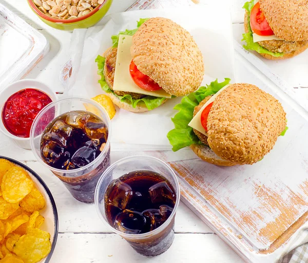 Fast food and cola in plastic cups — Stock Photo, Image