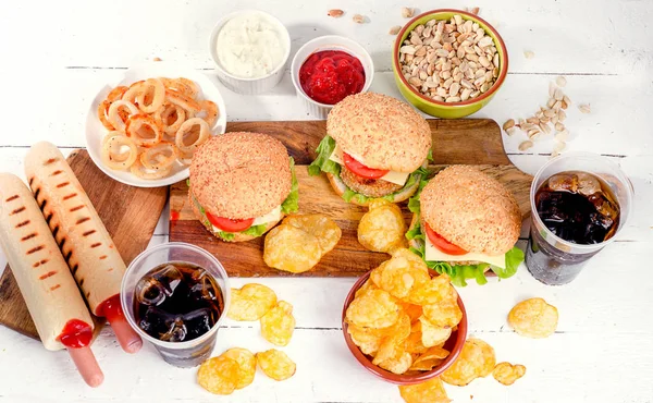 Fast food on cutting boards and in bowls — Stock Photo, Image