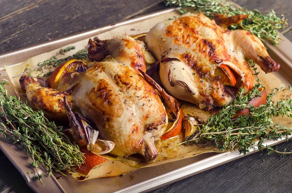Roasted whole chickens with oranges — Stock Photo, Image