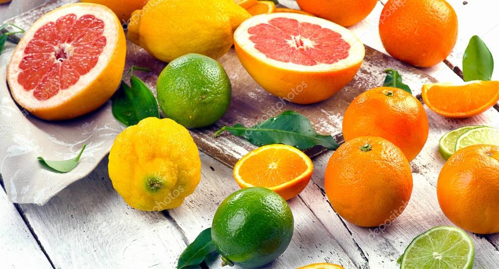 Fresh citrus fruits with cutting board 