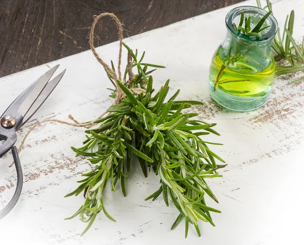 Rosemary and oil on board — Stock Photo, Image