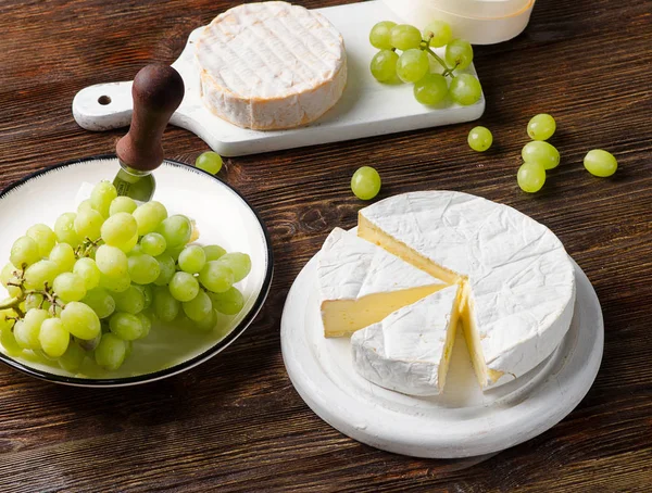 Brie on a rustic wooden board — Stock Photo, Image