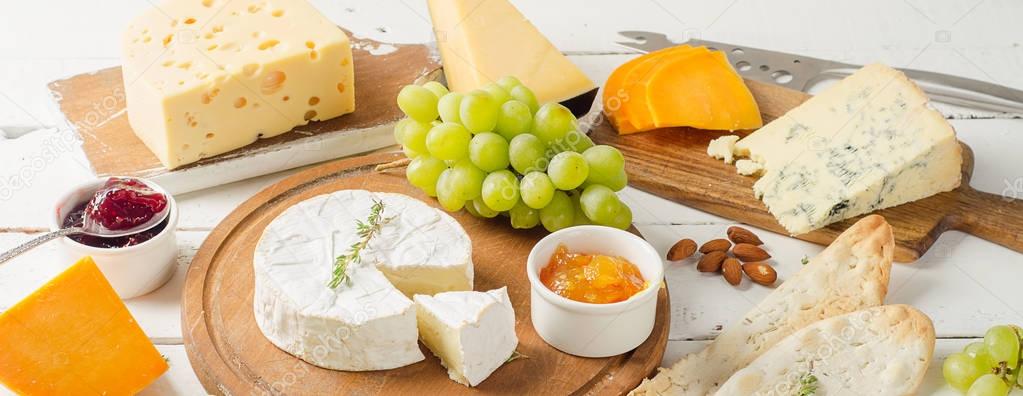Different kinds of cheeses with grapes
