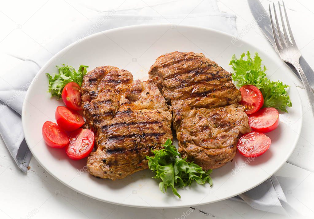 Grilled pork steaks