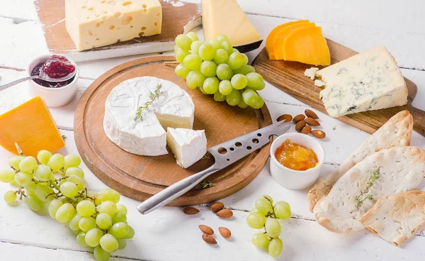 Cheese plates served with grapes, jam and nuts — Stock Photo, Image