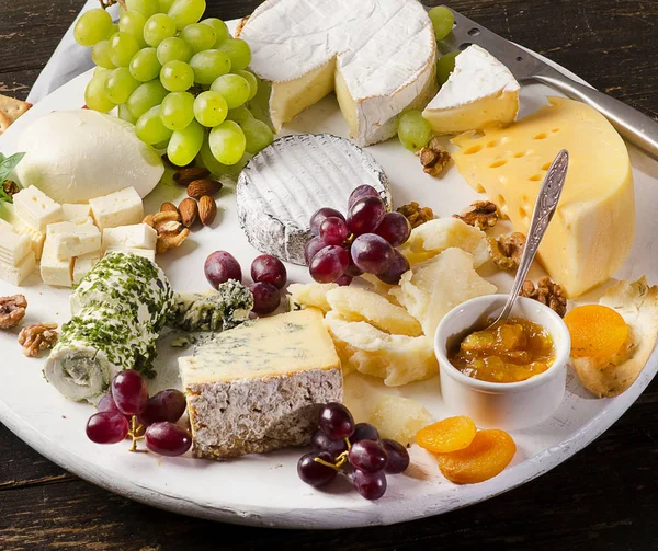 Cheese plates served with grapes, jam and nuts — Stock Photo, Image