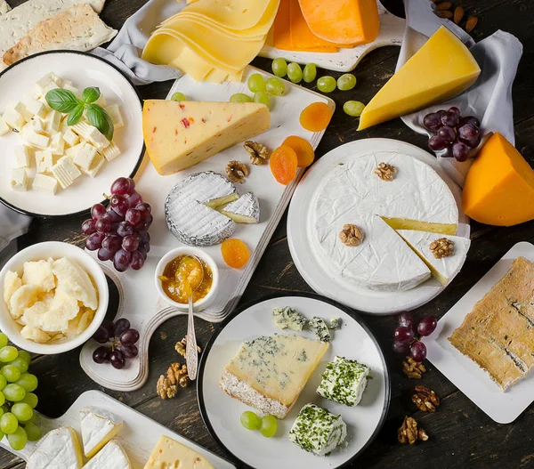 Cheese plates served with grapes, jam and nuts — Stock Photo, Image