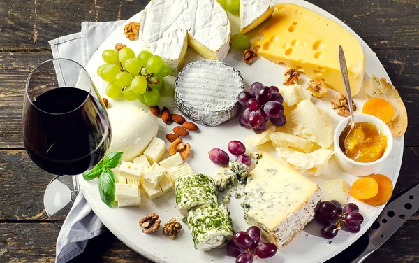Assiettes au fromage servies avec raisins, confiture et noix — Photo