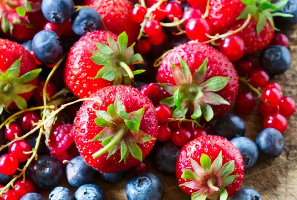 Mix of fresh berries on board. — Stock Photo, Image