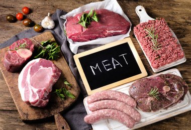 Koyu ahşap arka plan üzerinde taze çiğ et farklı türleri. 