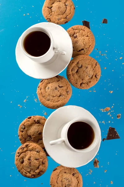 Cup of coffee with flying cookies