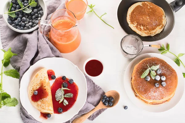 Healthy breakfast with coffee, pancakes, fresh berries and juice. Top view.