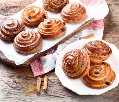 Tatlı tarçın, Kuru üzüm ve haşhaş tohumu Buns rustik masada.
