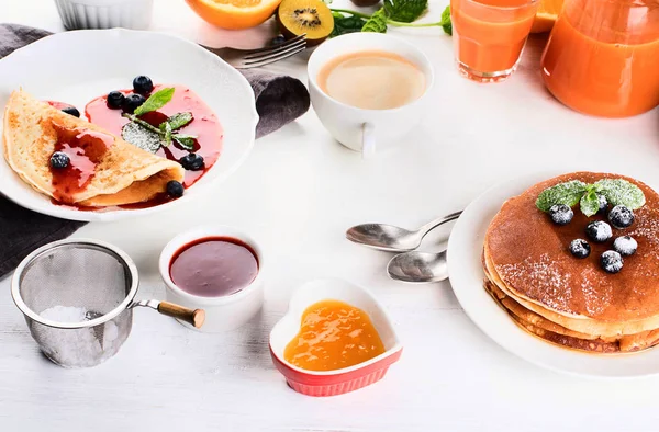 Healthy breakfast with coffee, pancakes, fresh berries and juice. Top view.