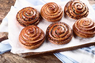 Tatlı tarçın, Kuru üzüm ve haşhaş tohumu Buns rustik masada.