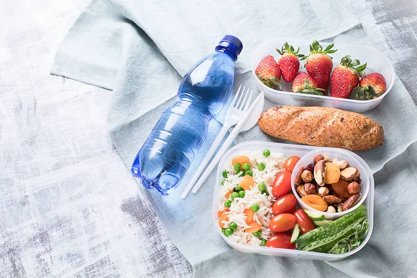 Healthy lunch boxes and bottle of water
