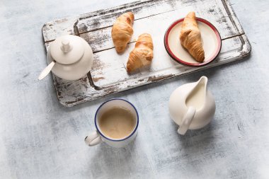 Kahvaltı üstten görünüm fincan kahve ve kruvasan ile