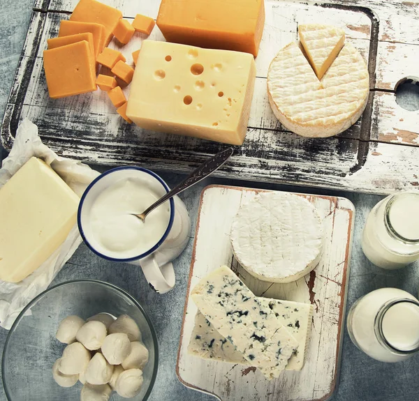 Top view of different dairy products on vintage table