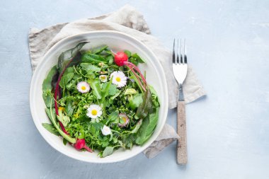 Yenilebilir çiçeklerle karışık salata yaprakları. Sağlıklı gıda konsepti. Kopyalama alanı olan üst görünüm