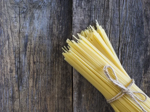 Spaghetti on wooden table — Stock Photo, Image