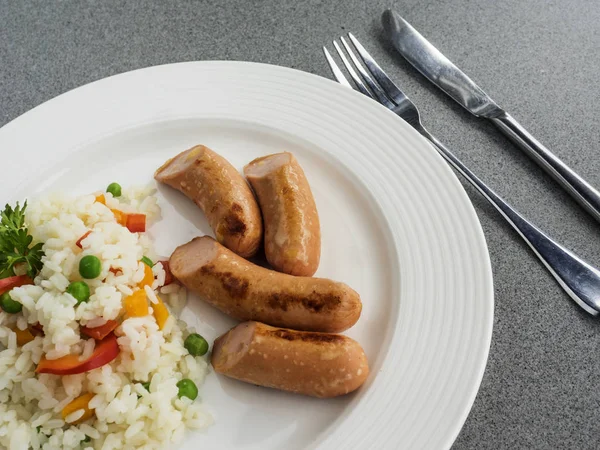 Sausages with boiled rice — Stock Photo, Image