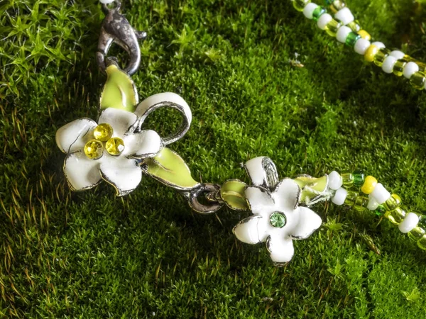 Bracelet with a clasp in the form of white flowers with ename — Stock Photo, Image