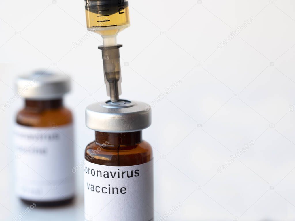 The world is anxiously awaiting a vaccine against coronavirus. The photo illustration shows two vials labeled Coronavirus vaccine and syringe.