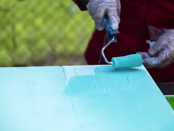 Woman Hand Paints Sheet Plywood Turquoise Color Roller — Stock Photo, Image