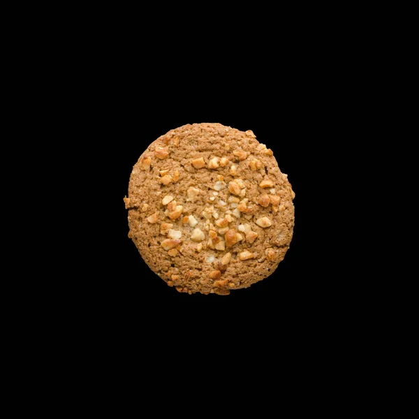 Oatmeal cookie with nuts isolated on black background — Stock Photo, Image
