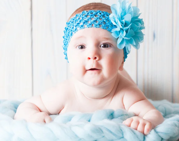 Cute baby girl with blue bandage — Stock Photo, Image