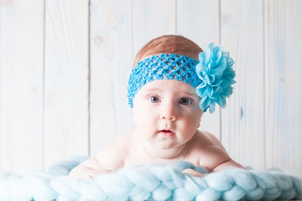 Cute baby girl with blue bandage — Stock Photo, Image