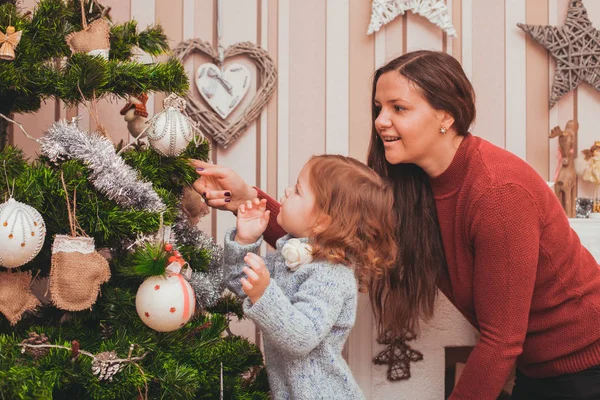 Mamma och dotter dekorera julgran — Stockfoto