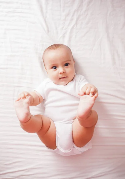 Portrait of a baby lying on the bed — Stock Photo, Image