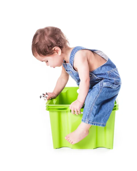 Kid plays with container — Stock Photo, Image