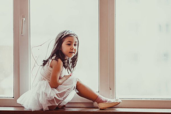 Dreamy girl at the window