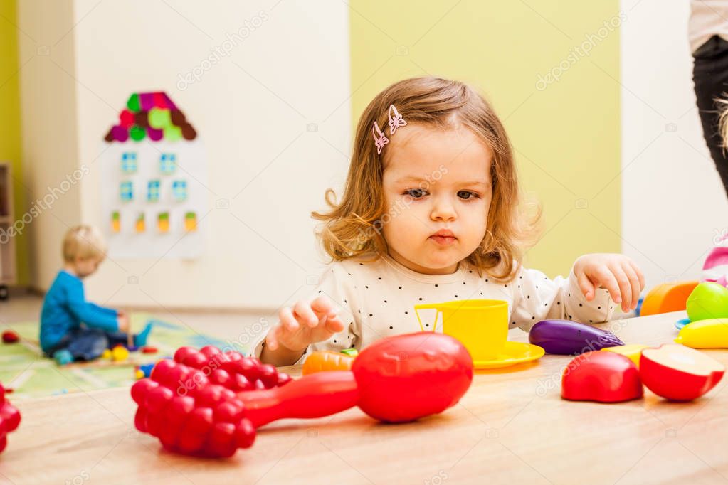 Girl plays with fruits