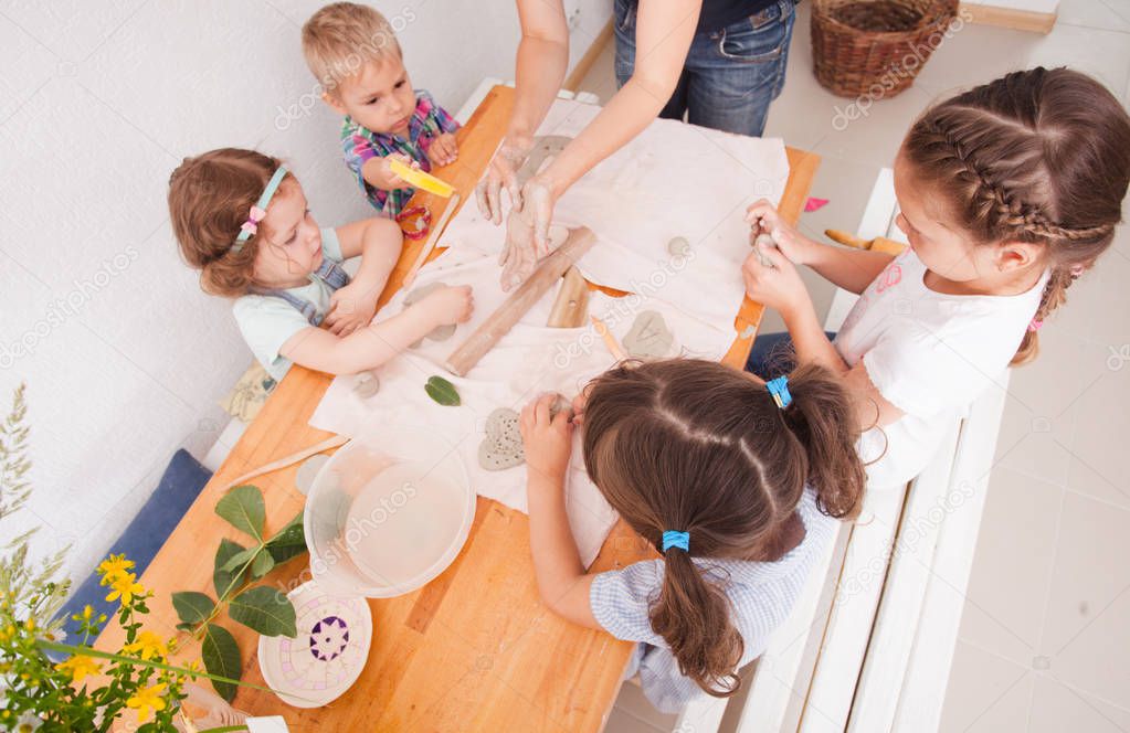 Happy children are engaged with modeling clay