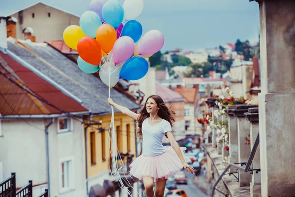 Girl with colorful latex balloons — Stock Photo, Image