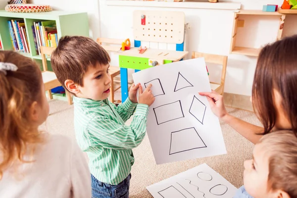 Leraar leert kinderen verschillende cijfers — Stockfoto