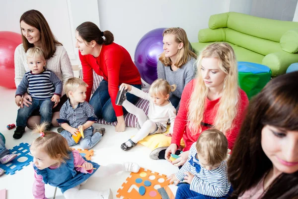Young moms with their kids — Stock Photo, Image