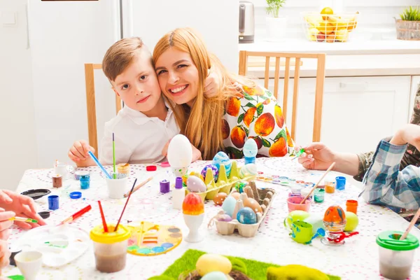 Portrait of mother and her son embracing during Easter workshop