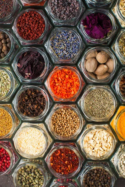 Assorted colorful spices and herbs in bottles — Stockfoto