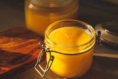 Glass jar with ghee - clarified butter at kitchen