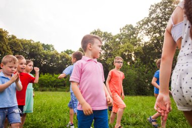 Happy children playing outdoors games in a park