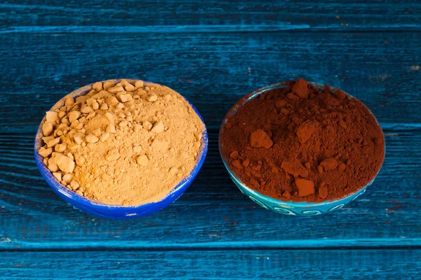 Organic carob and cacao powder in bowls. Natural cocoa substitute. — Stok fotoğraf