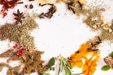 Art composition with different aromatic spices on white background