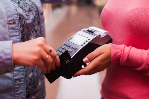 Woman using payment terminal. Credit card payment.