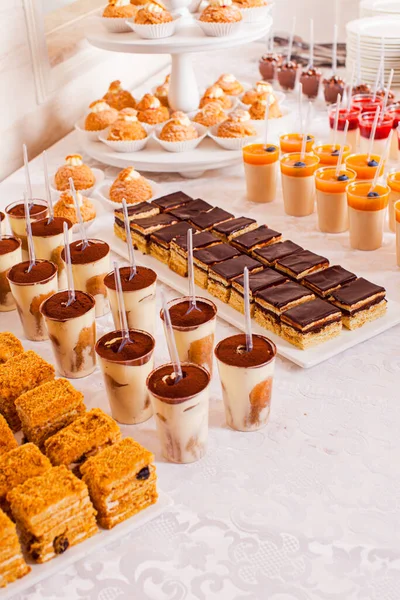 Catering waitress service. Variety of desserts on the table — Stock Photo, Image