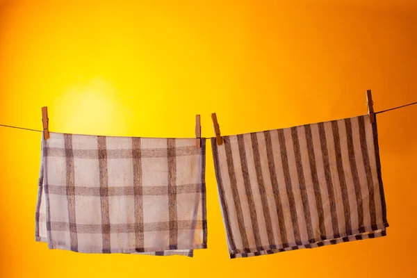 Eco friendly household items. Washed towels with wooden clothespins hanging on the rope — 图库照片
