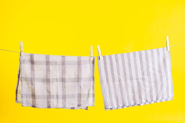 Towel drying after washing isolated on a yellow — Stock Photo, Image